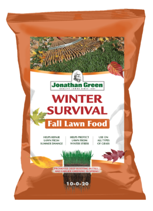 Bag of Winter Survival Fall Lawn Fertilizer, with product benefits listed on the orange front label amidst autumn leaves.