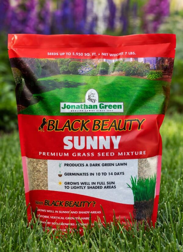 A bag of Grass Seed & Fertilizer Bundle for Sunny Lawns on a grassy background.