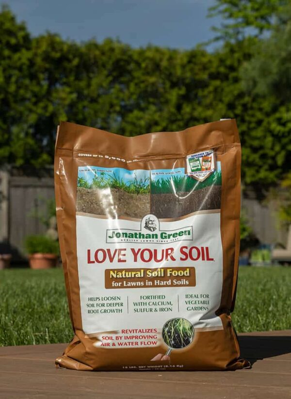 A bag of Jonathan Green natural soil food for Summer Lawn Care Bundle, standing upright on a grassy surface.