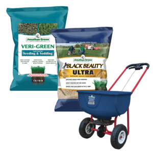 Two bags of Lawn Starter Kit, one for seeding and another for grass care, alongside a blue spreader on a white background.