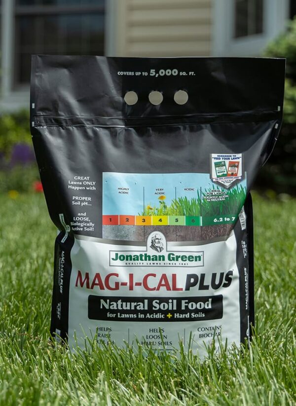 Bag of Grass Seed & Fertilizer Bundle for Acidic Soil displayed on grass.