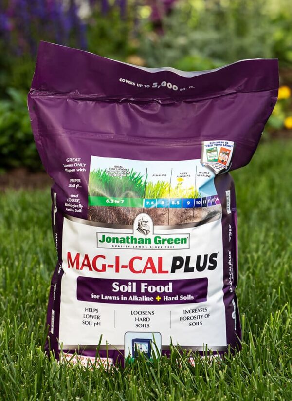 Bag of Grass Seed & Fertilizer Bundle for Alkaline Soil on a grassy background.