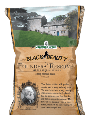 A bag of Black Beauty® Founders Reserve Grass Seed featuring a historic house and lawn, product details, and Jonathan Green’s portrait on the packaging.