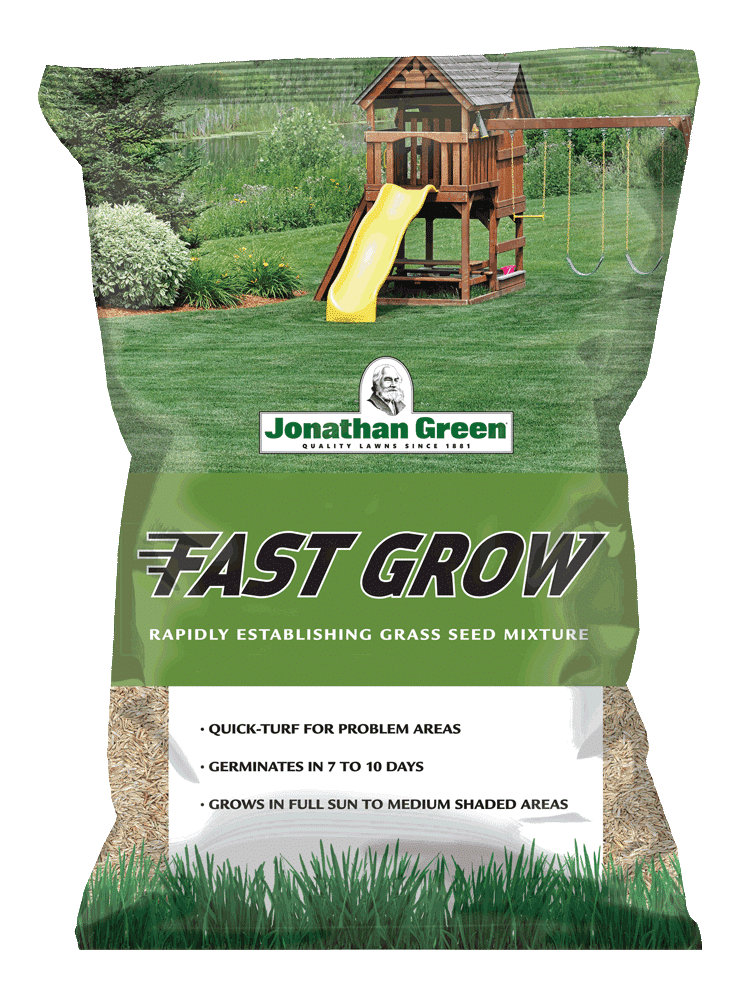 A bag of Fast Grow Grass Seed mixture with information highlights, placed against a backdrop of a lush lawn with a wooden playset.