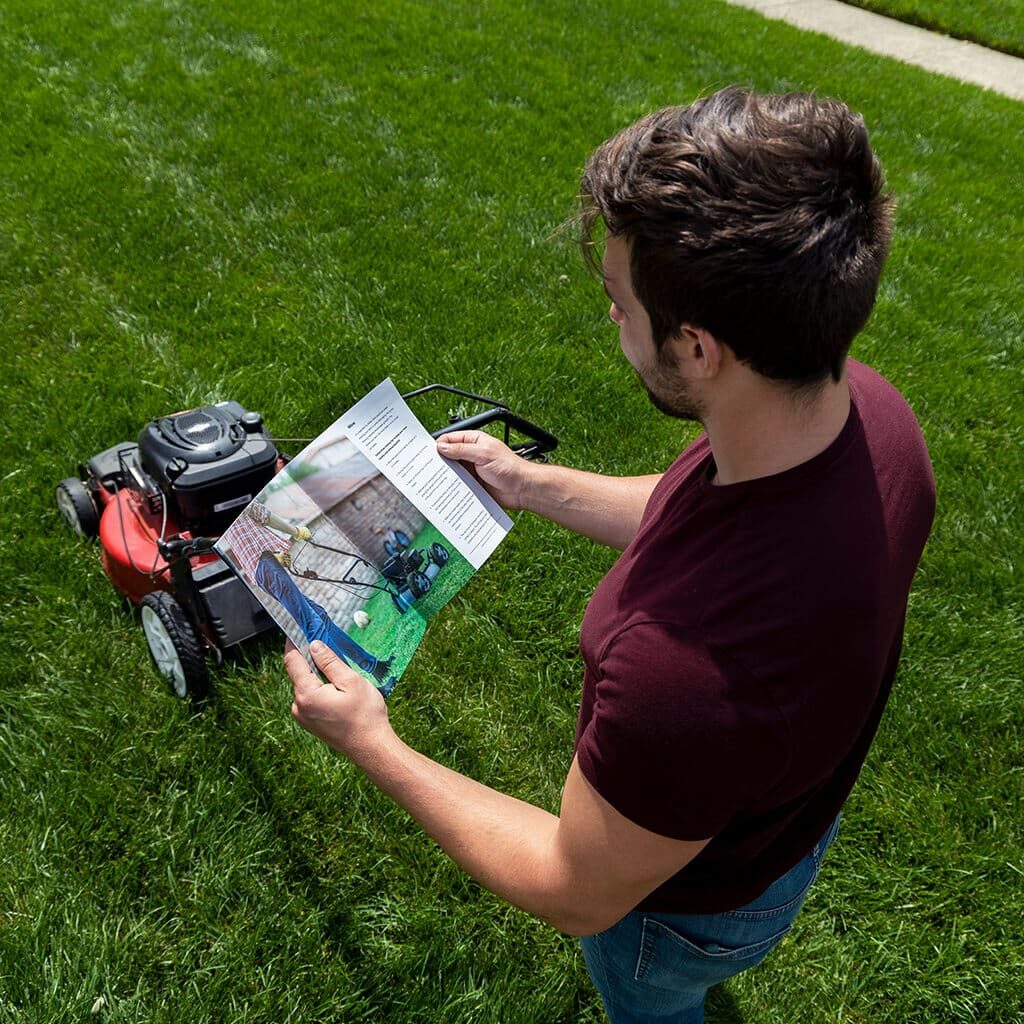 man-lawn-mower-reading-Jonathan-Green-lawn-guide-scaled